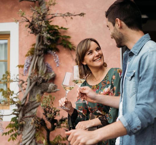 A couple is clinking glasses