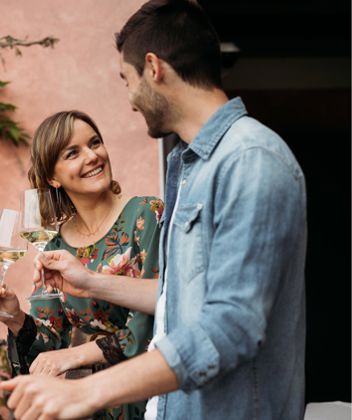 Two people are clinking their glasses