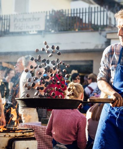 A man is roasting chestnuts