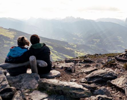 Two hikers enjoy the view in summer